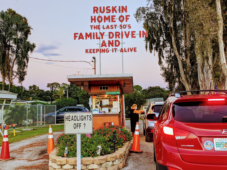 a car parked in front of a sign