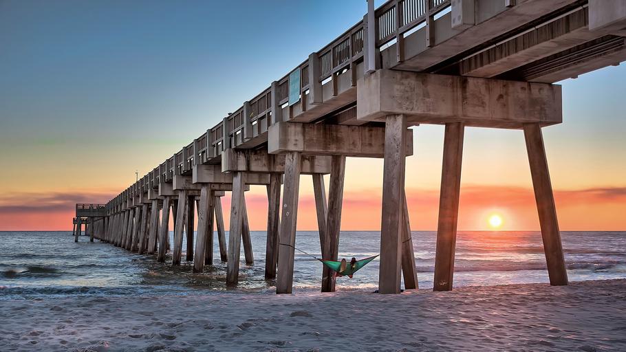 a close up of a pier next to a body of water