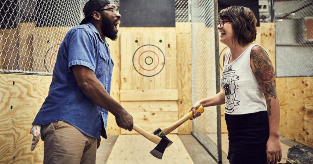 a man and woman holding an ax