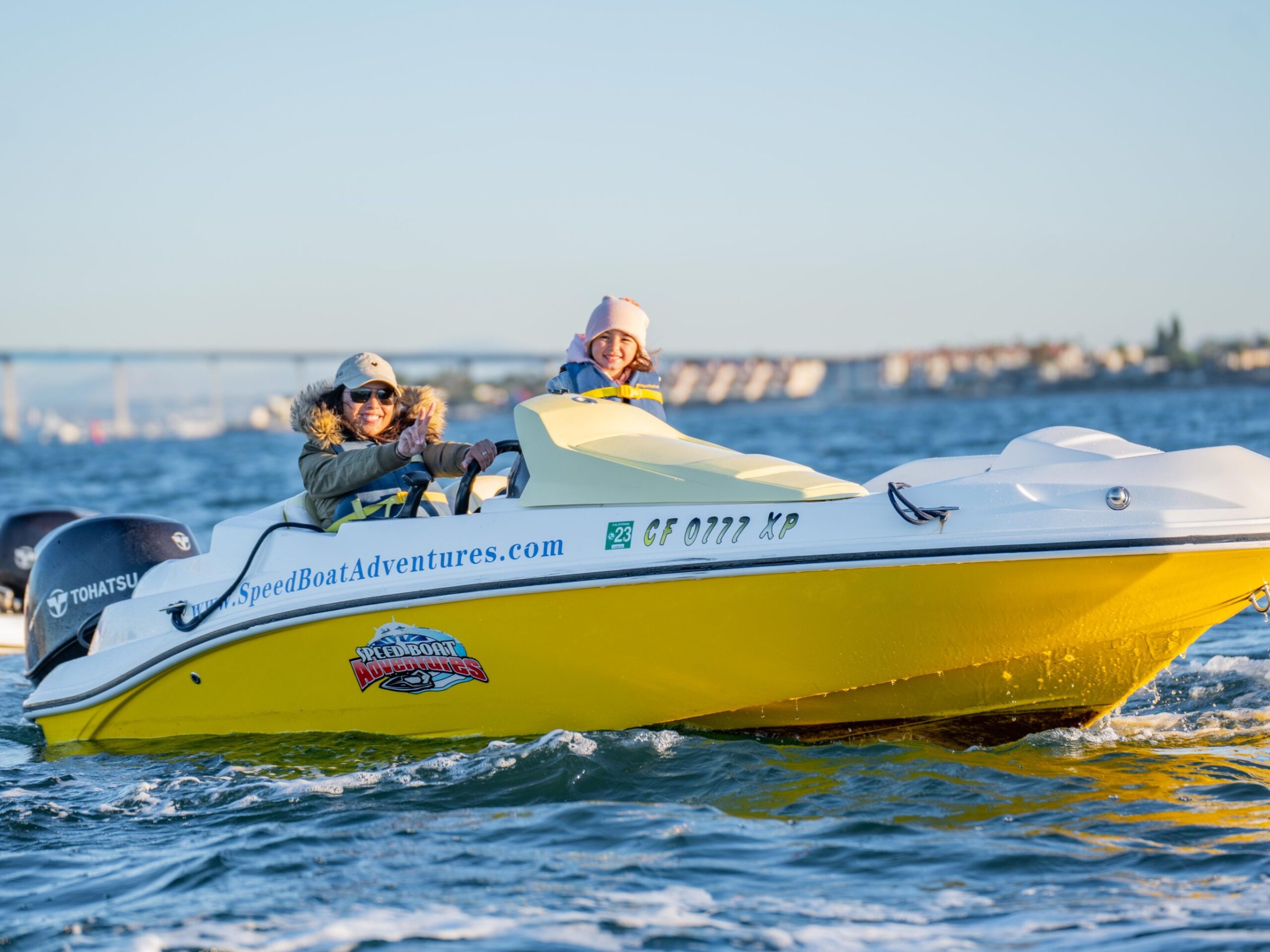 a person riding on the back of a boat in the water